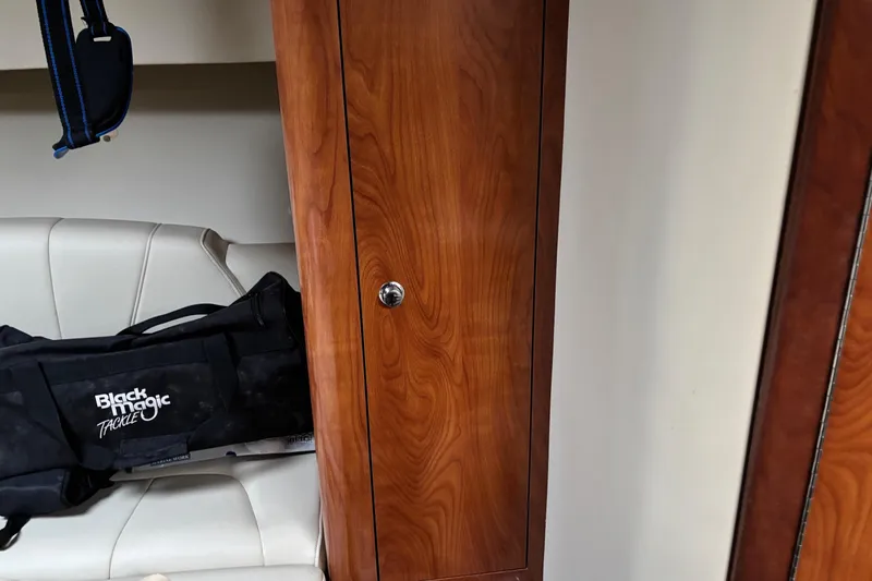 Yacht Photos Pics Interior of 2009 Fountain 33 Sportfish Cruiser with wooden cabinet and Black Magic Tackle bag.