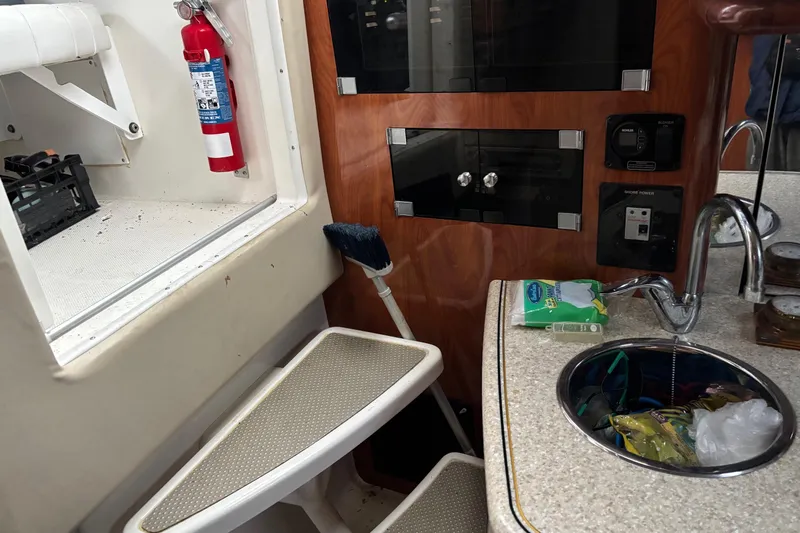  Yacht Photos Pics Interior of 2009 Fountain 33 Sportfish Cruiser with sink, fire extinguisher, and storage.