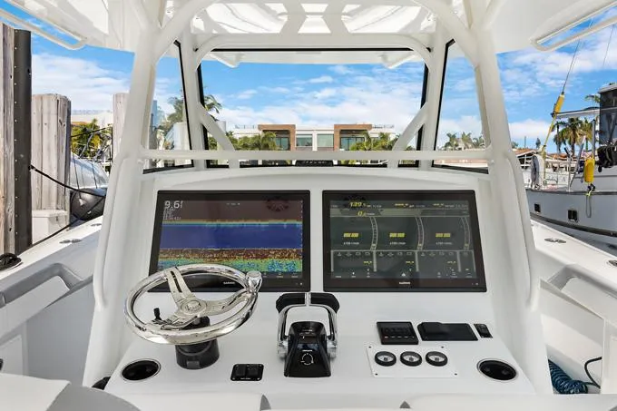 Seas The Day Yacht Photos Pics 2020 Yellowfin 39 Center Console boat dashboard with dual screens and steering wheel.