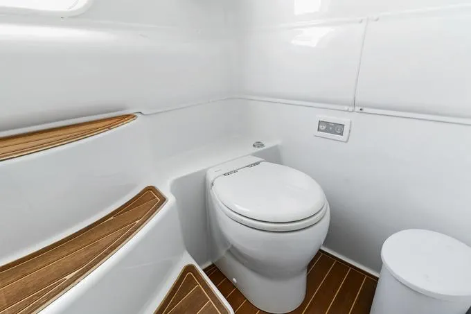 Seas The Day Yacht Photos Pics 2020 Yellowfin 39 Center Console boat bathroom with modern toilet and wooden flooring.