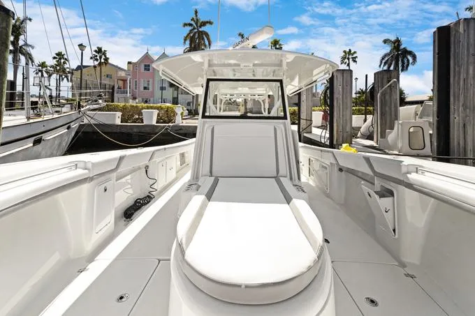 Seas The Day Yacht Photos Pics 2020 Yellowfin 39 Center Console boat docked in marina, clear sky, palm trees.
