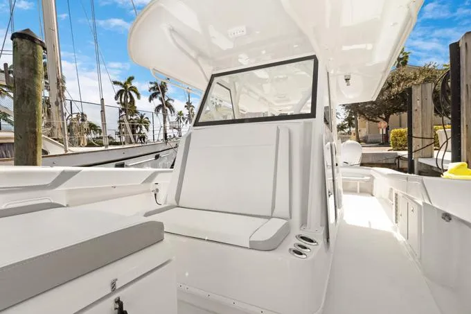 Seas The Day Yacht Photos Pics 2020 Yellowfin 39 Center Console boat interior with seating and helm, docked under clear skies.