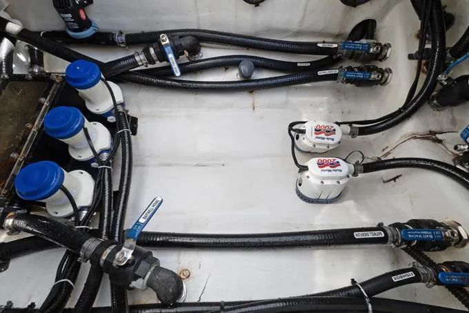 Seas The Day Yacht Photos Pics 2020 Yellowfin 39 Center Console engine compartment with hoses and pumps.