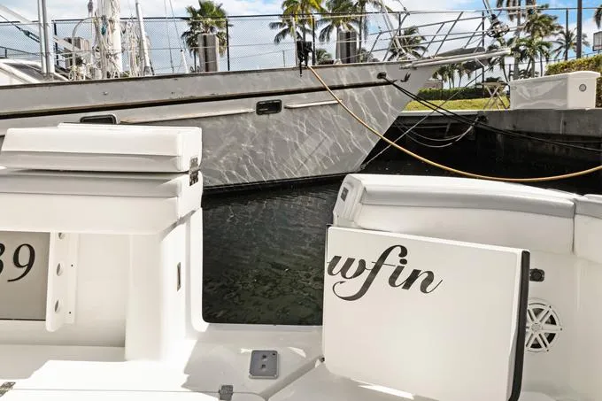 Seas The Day Yacht Photos Pics 2020 Yellowfin 39 Center Console boat docked near other vessels.