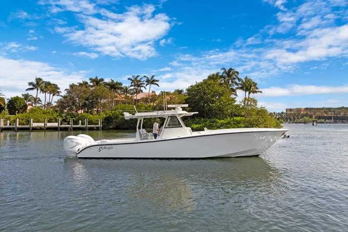 Seas The Day Yacht Photos Pics 2020 Yellowfin 39 Center Console boat on a scenic waterway with palm trees.