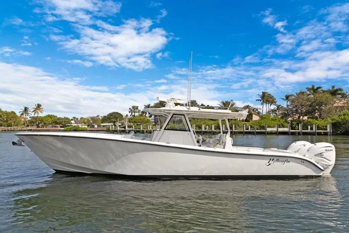Seas The Day Yacht Photos Pics 2020 Yellowfin 39 Center Console boat on a calm waterway under a blue sky.