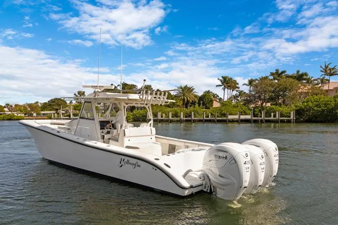 Seas The Day Yacht Photos Pics 2020 Yellowfin 39 Center Console boat with triple outboard engines on a sunny day.
