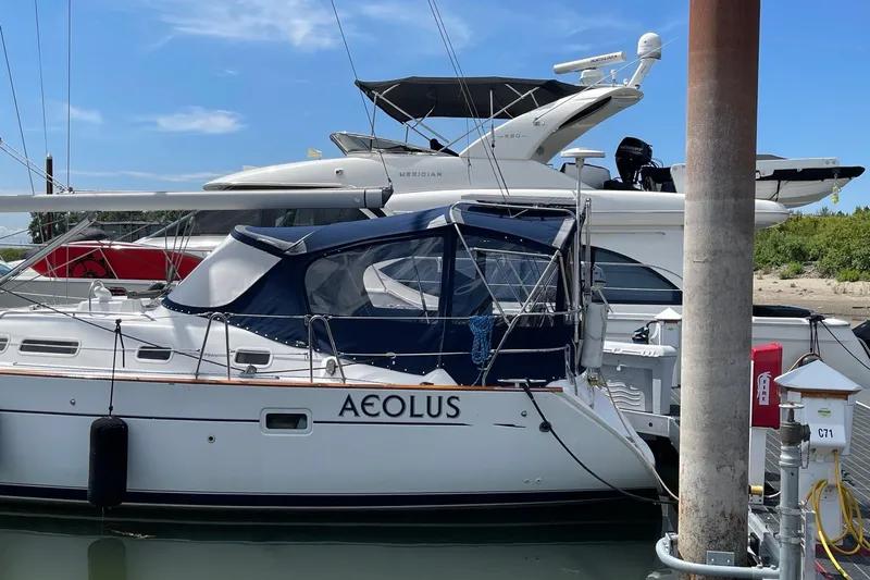 Aeolus Yacht Photos Pics Sailboat "Aeolus," 2007 Beneteau 423, docked with other yachts in a marina.