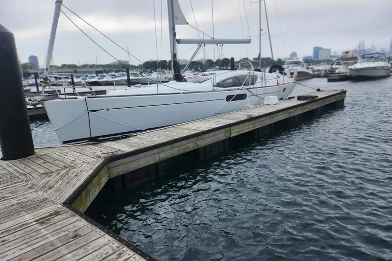 Vilia Yacht Photos Pics 2010 Jeanneau Sun Odyssey 45 DS sailboat docked at marina, overcast sky.