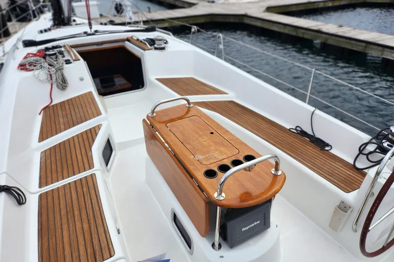Vilia Yacht Photos Pics 2010 Jeanneau Sun Odyssey 45 DS sailboat cockpit with wooden seating and storage.