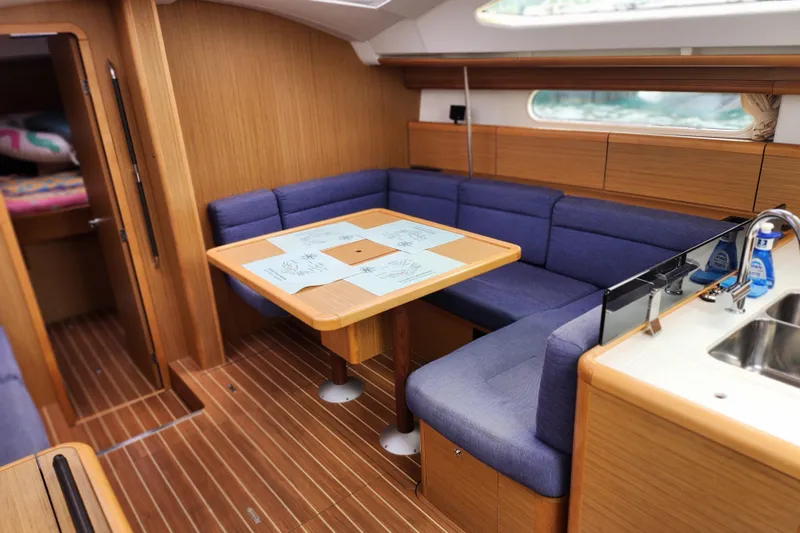 Vilia Yacht Photos Pics Interior of 2010 Jeanneau Sun Odyssey 45 DS yacht with cozy seating and dining area.