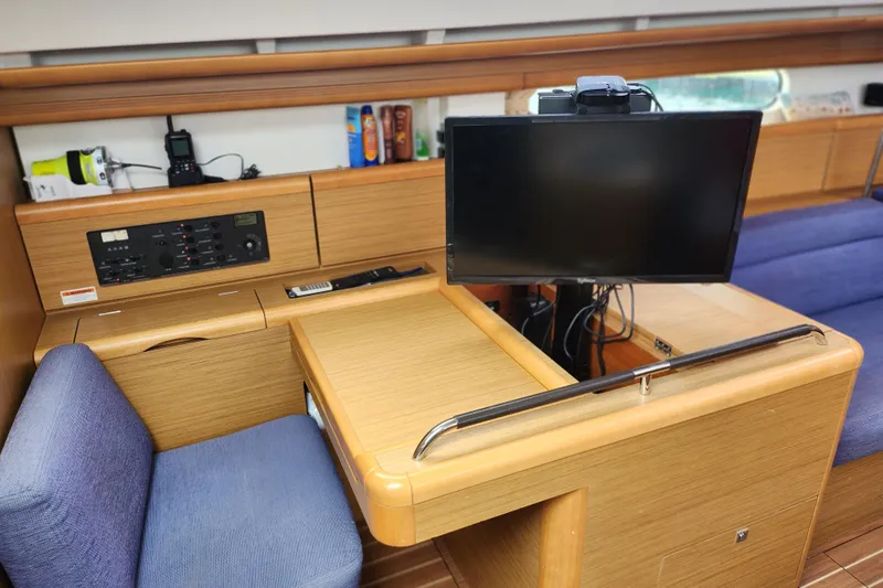 Vilia Yacht Photos Pics Interior of 2010 Jeanneau Sun Odyssey 45 DS yacht with navigation station and monitor.
