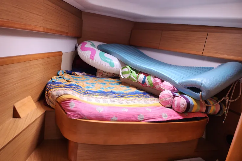 Vilia Yacht Photos Pics Cozy cabin interior of 2010 Jeanneau Sun Odyssey 45 DS with colorful bedding and inflatables.