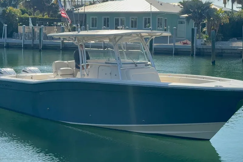 Repowered Yacht Photos Pics 2011 Grady-White Canyon 336 boat docked in a serene marina setting.