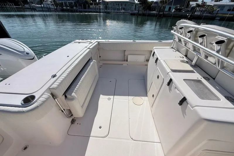 Repowered Yacht Photos Pics 2011 Grady-White Canyon 336 boat interior with seating and storage, docked by calm waters.
