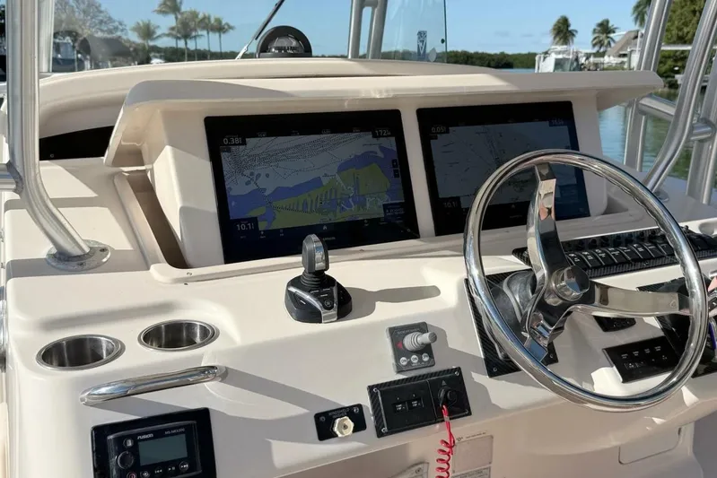 Repowered Yacht Photos Pics 2011 Grady-White Canyon 336 boat dashboard with navigation screens and steering wheel.