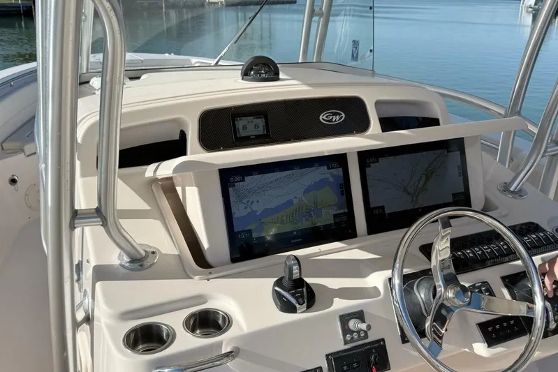 Repowered Yacht Photos Pics 2011 Grady-White Canyon 336 boat dashboard with navigation screens and steering wheel.
