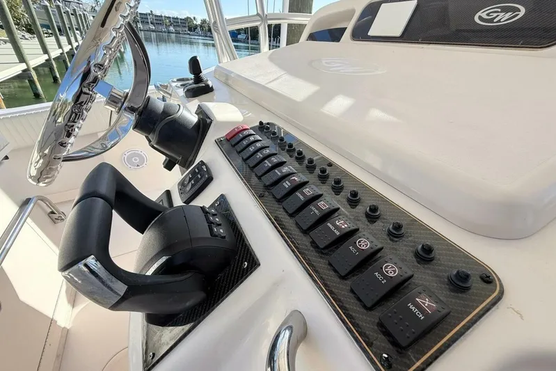 Repowered Yacht Photos Pics 2011 Grady-White Canyon 336 helm with steering wheel and control panel.