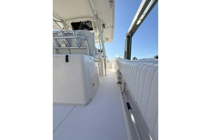 Repowered Yacht Photos Pics 2011 Grady-White Canyon 336 boat interior with seating and railing, under clear blue sky.