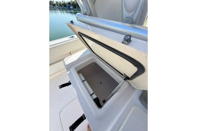 Repowered Yacht Photos Pics Open storage compartment on 2011 Grady-White Canyon 336 boat, near calm waters.