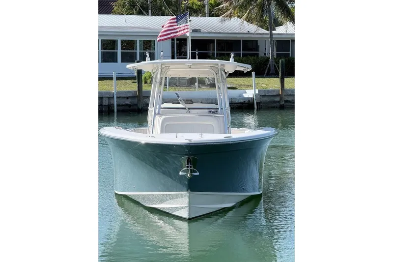 Repowered Yacht Photos Pics 2011 Grady-White Canyon 336 boat docked, front view with American flag.