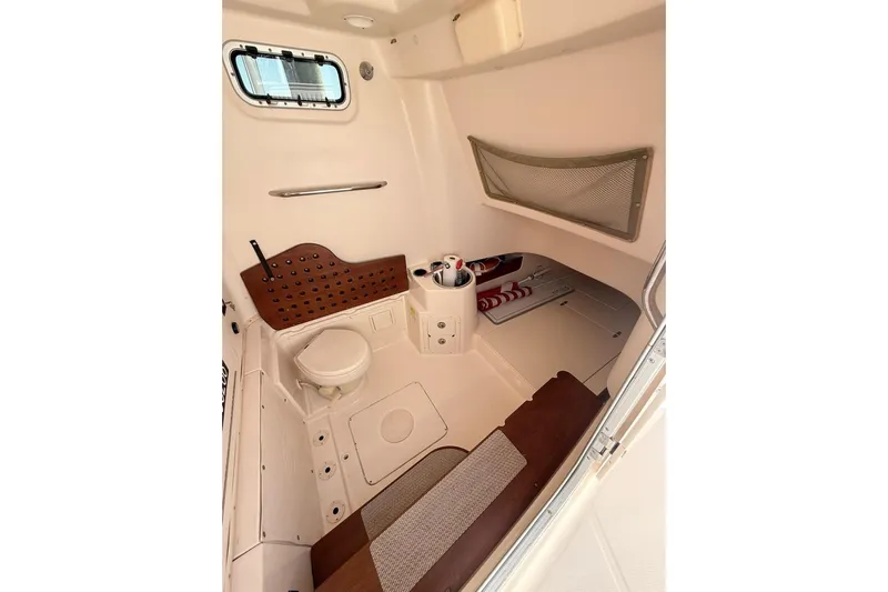 Repowered Yacht Photos Pics 2011 Grady-White Canyon 336 cabin interior with seating and storage.