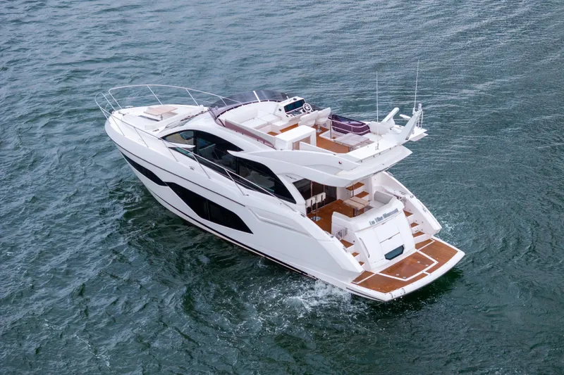 In The Moment Yacht Photos Pics 2018 Sunseeker Manhattan 52 yacht cruising on open water, showcasing luxury design.