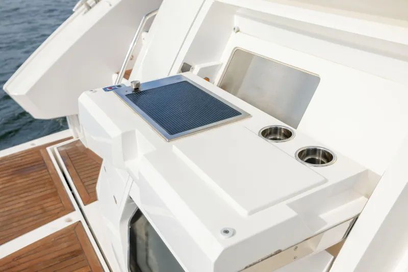 In The Moment Yacht Photos Pics Outdoor kitchen area on 2018 Sunseeker Manhattan 52 yacht with wooden deck.
