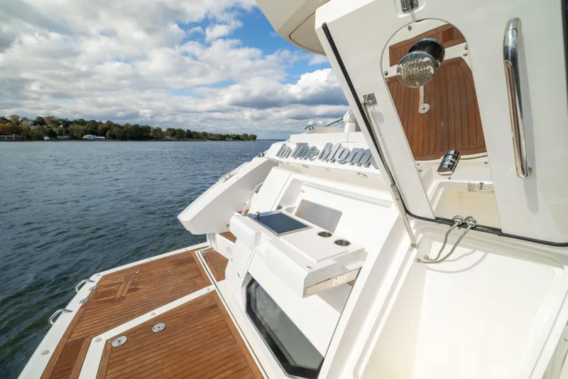 In The Moment Yacht Photos Pics 2018 Sunseeker Manhattan 52 yacht on water, featuring sleek deck design and modern amenities.