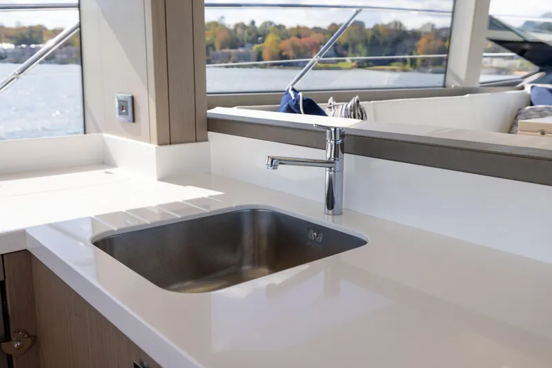 In The Moment Yacht Photos Pics Modern kitchen sink on 2018 Sunseeker Manhattan 52 yacht with scenic water view.