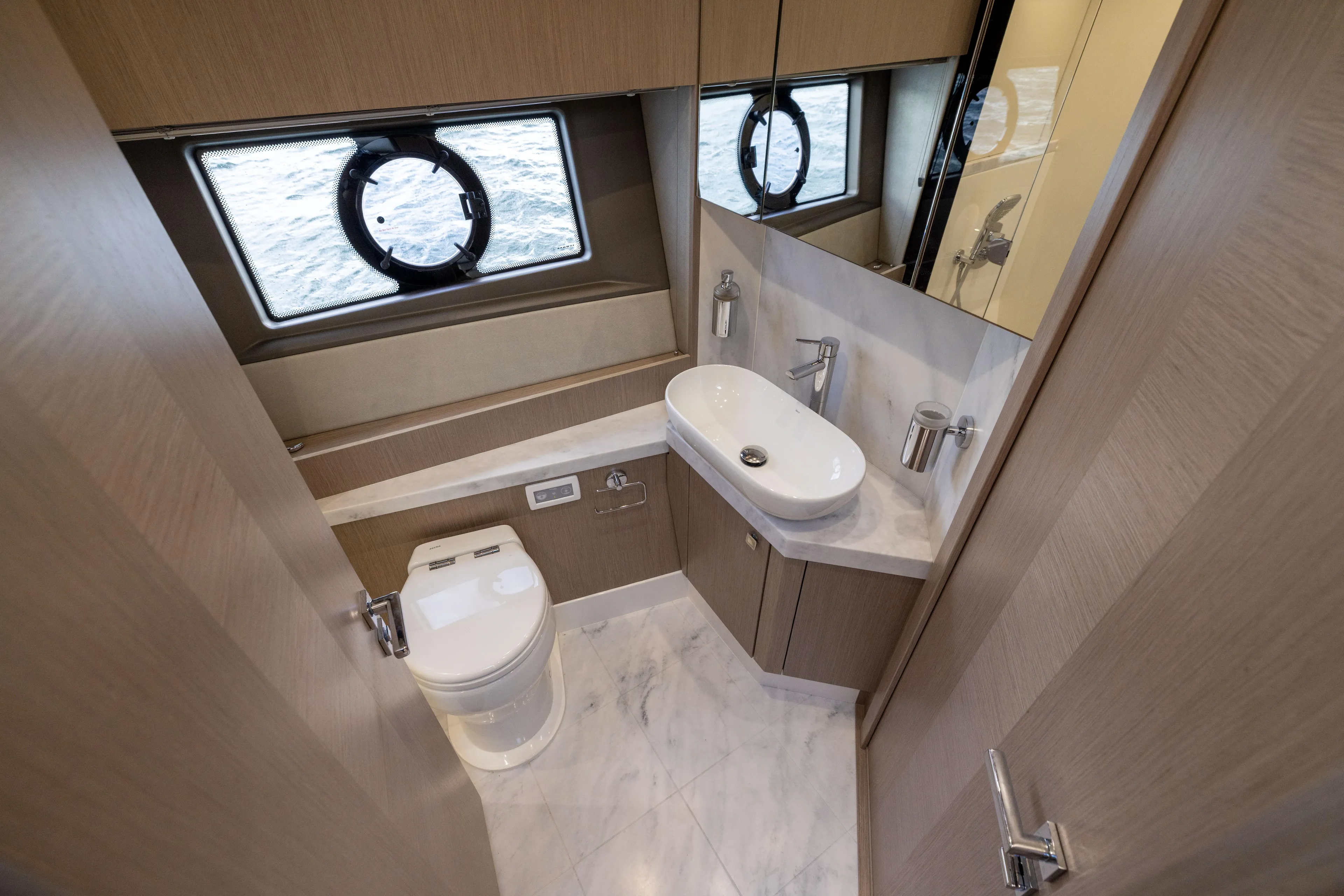In The Moment Yacht Photos Pics Luxurious bathroom in 2018 Sunseeker Manhattan 52 yacht with modern fixtures and ocean view.