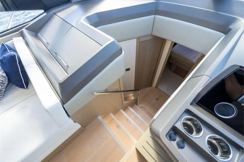 In The Moment Yacht Photos Pics Interior view of 2018 Sunseeker Manhattan 52 yacht, featuring modern design and wooden stairs.