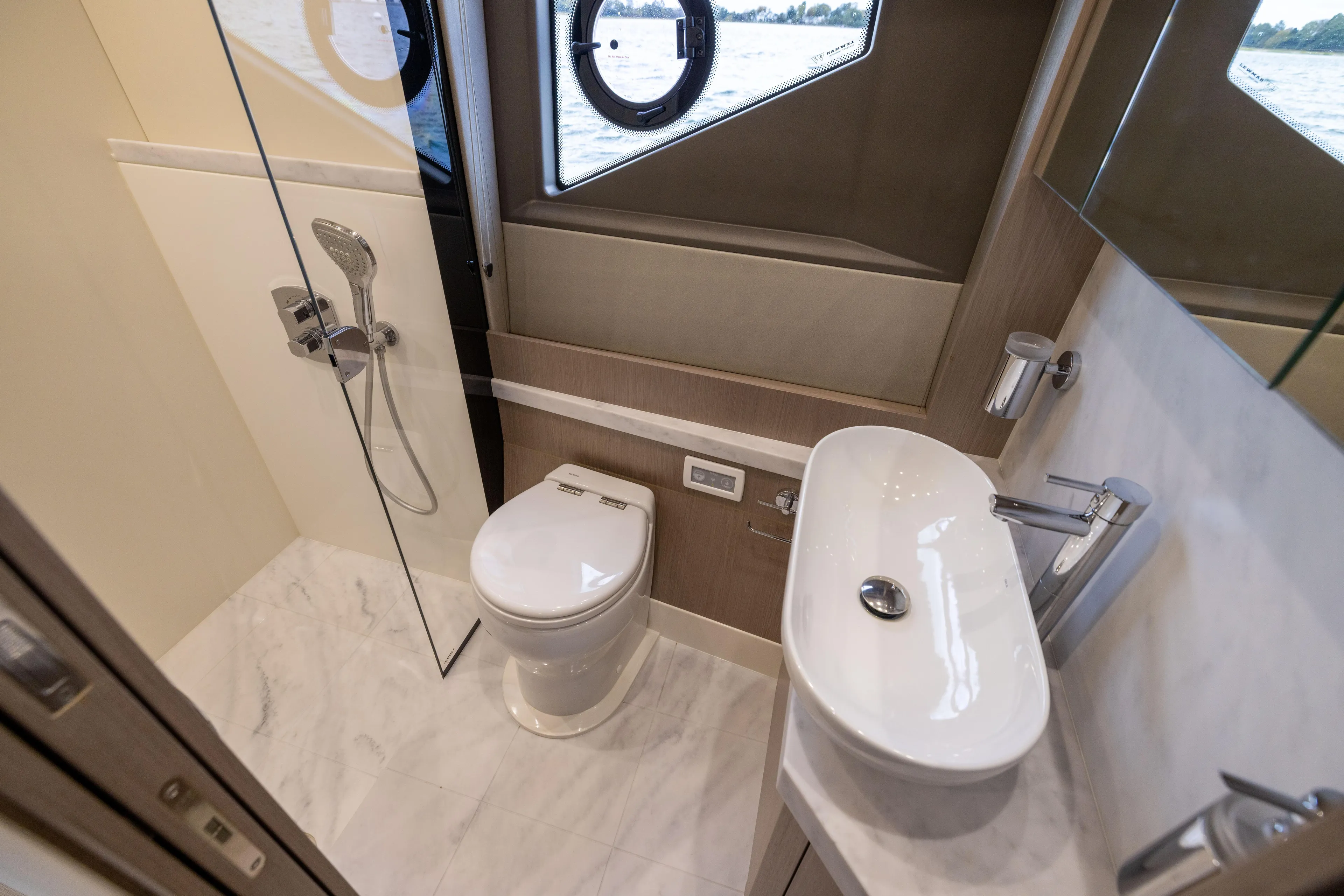 In The Moment Yacht Photos Pics Luxurious bathroom in 2018 Sunseeker Manhattan 52 yacht with modern fixtures and ocean view.