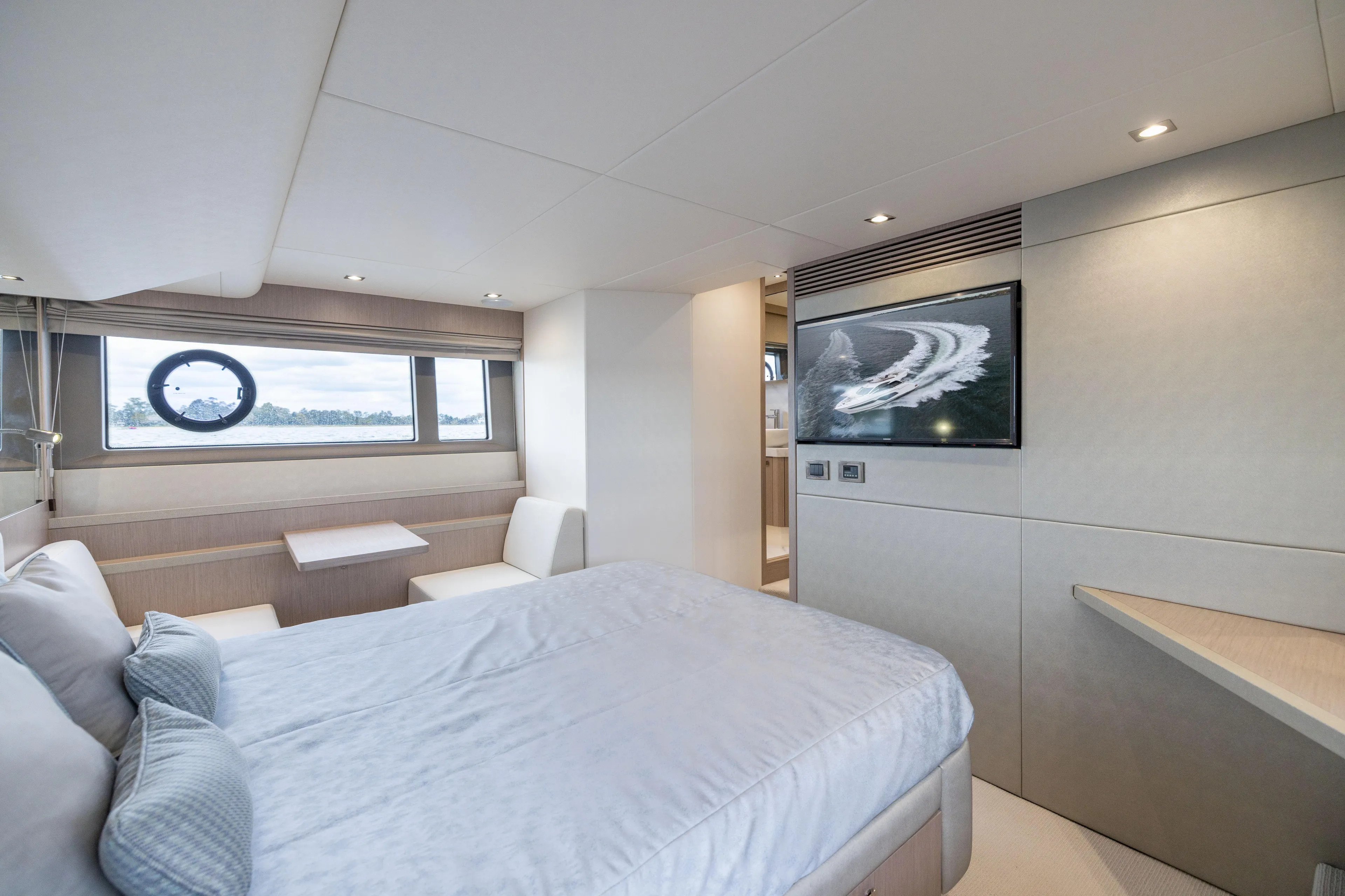 In The Moment Yacht Photos Pics Luxurious interior of 2018 Sunseeker Manhattan 52 yacht with modern bedroom and scenic window view.