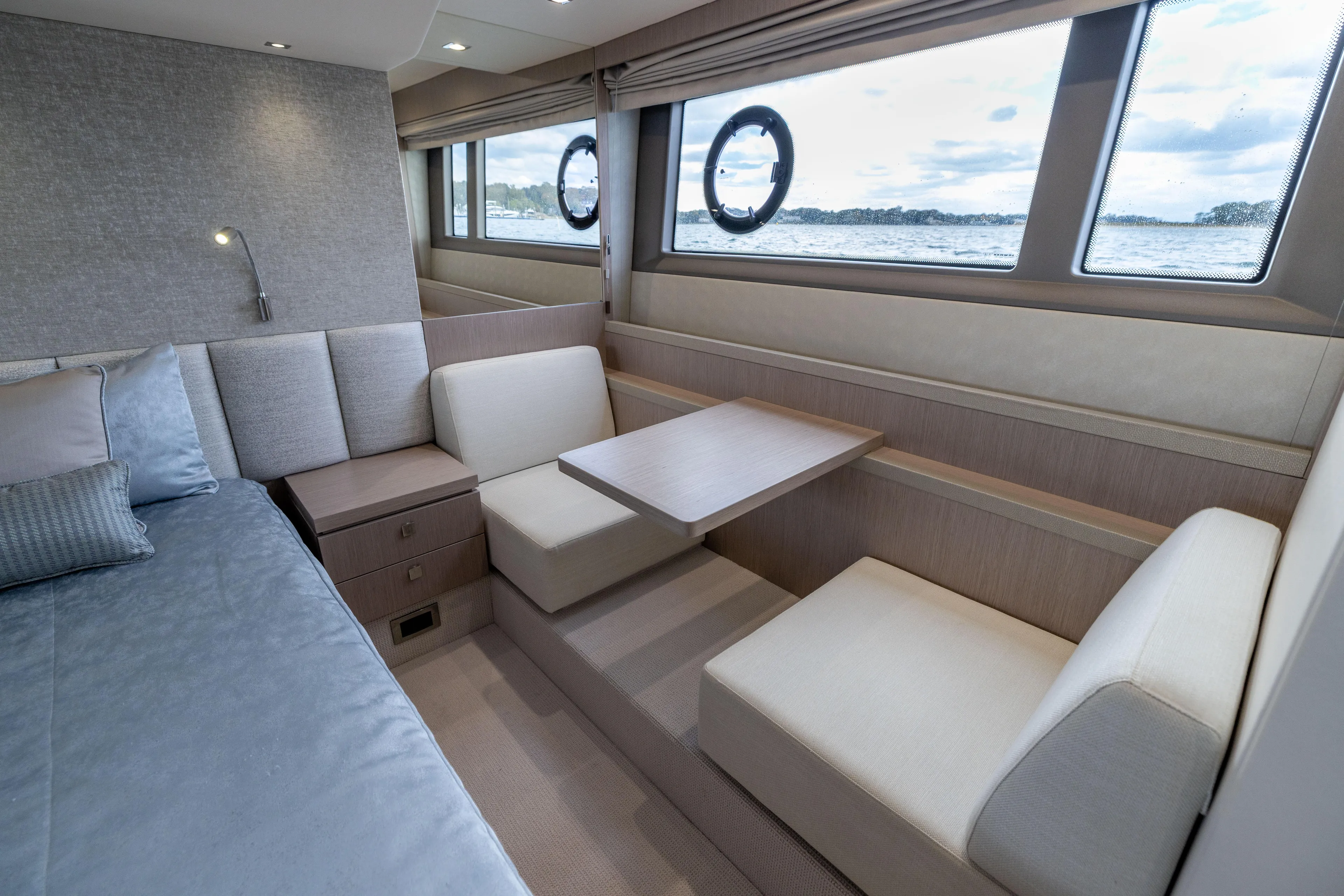 In The Moment Yacht Photos Pics Luxurious interior of 2018 Sunseeker Manhattan 52 yacht with elegant seating and ocean view.