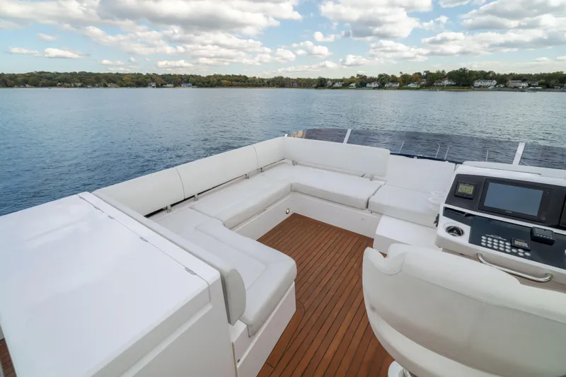 In The Moment Yacht Photos Pics Luxurious 2018 Sunseeker Manhattan 52 yacht deck with white seating and scenic water view.