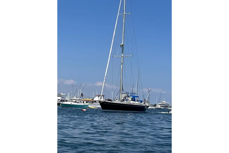 Yacht Photos Pics Sailing yacht Nautor Swan 61, 1990 model, anchored in a bustling marina.
