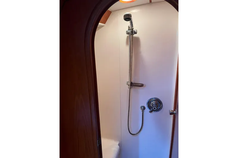  Yacht Photos Pics Shower area in 1990 Nautor Swan 61 yacht, featuring chrome fixtures and wooden trim.