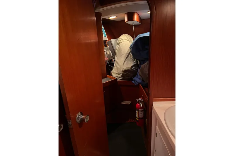  Yacht Photos Pics Interior of 1990 Nautor Swan 61 yacht with wooden paneling and fire extinguisher.