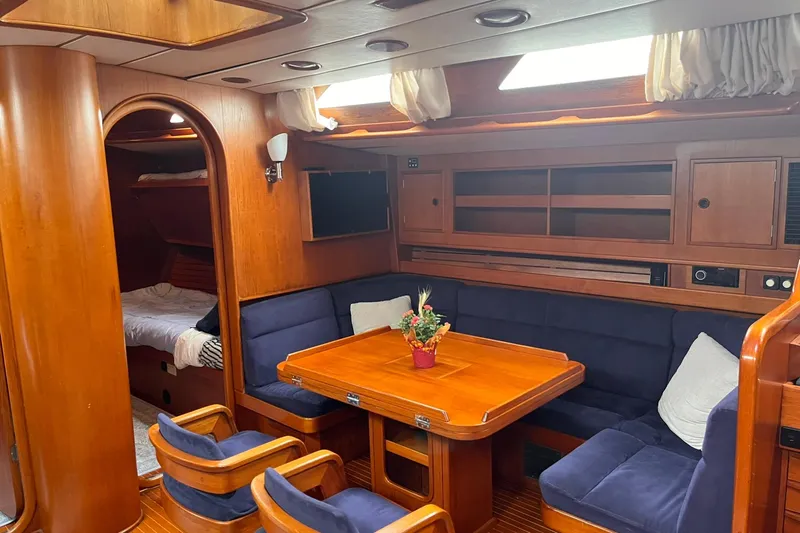  Yacht Photos Pics Luxurious 1990 Nautor Swan 61 yacht interior with wooden furnishings and cozy seating area.
