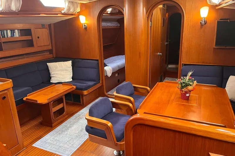  Yacht Photos Pics Luxurious 1990 Nautor Swan 61 yacht interior with wooden furnishings and cozy seating.
