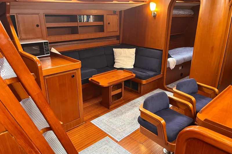  Yacht Photos Pics Interior of 1990 Nautor Swan 61 yacht with wooden furnishings and cozy seating area.