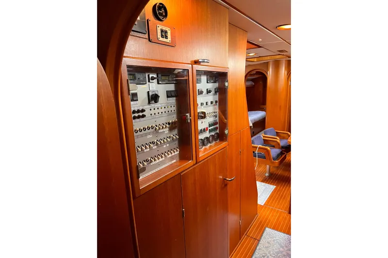  Yacht Photos Pics Interior of 1990 Nautor Swan 61 yacht, featuring wooden cabinetry and control panel.
