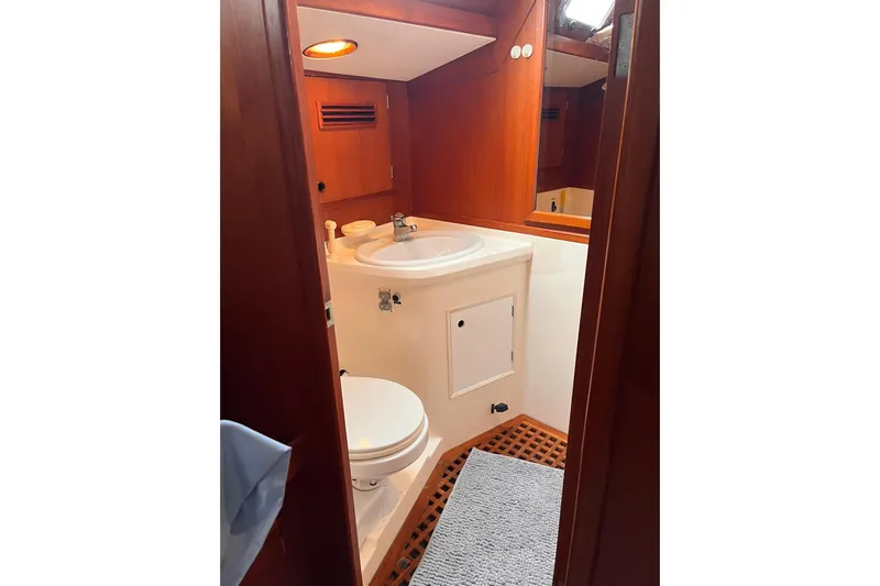  Yacht Photos Pics Bathroom interior of 1990 Nautor Swan 61 yacht with wooden accents and modern fixtures.