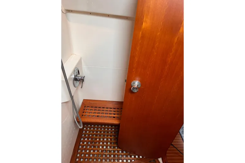  Yacht Photos Pics Shower area on 1990 Nautor Swan 61 yacht with wooden flooring and door.