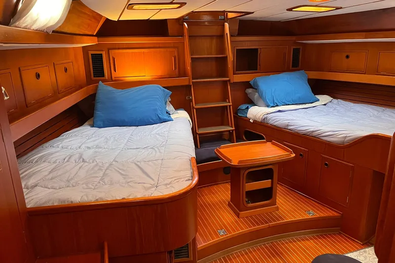  Yacht Photos Pics Luxurious 1990 Nautor Swan 61 yacht cabin with twin beds and wooden interior.