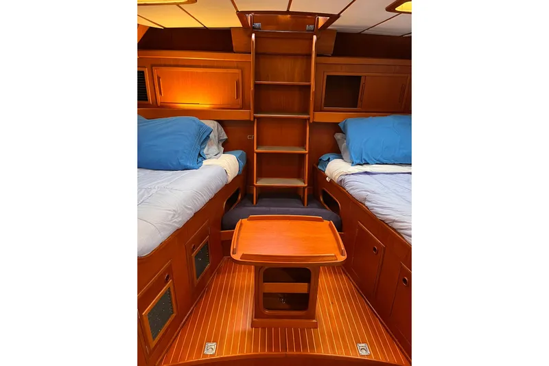  Yacht Photos Pics Interior of 1990 Nautor Swan 61 yacht with twin beds and wooden cabinetry.
