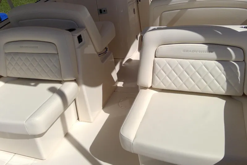  Yacht Photos Pics 2023 Grady-White Freedom 285 boat interior with luxurious white seating.