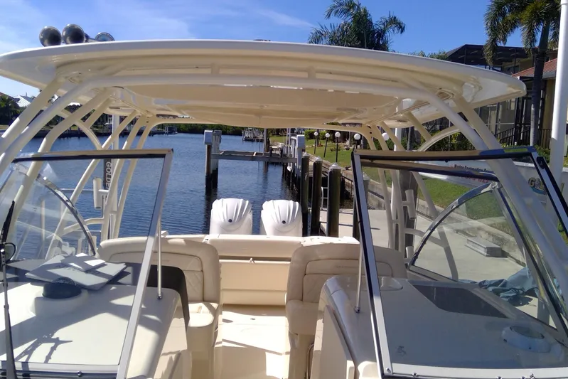  Yacht Photos Pics 2023 Grady-White Freedom 285 boat docked, featuring dual engines and spacious seating.