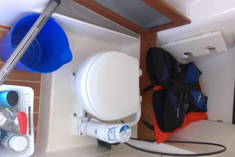  Yacht Photos Pics Interior of 2023 Grady-White Freedom 285 boat with toilet, life jackets, and cleaning supplies.
